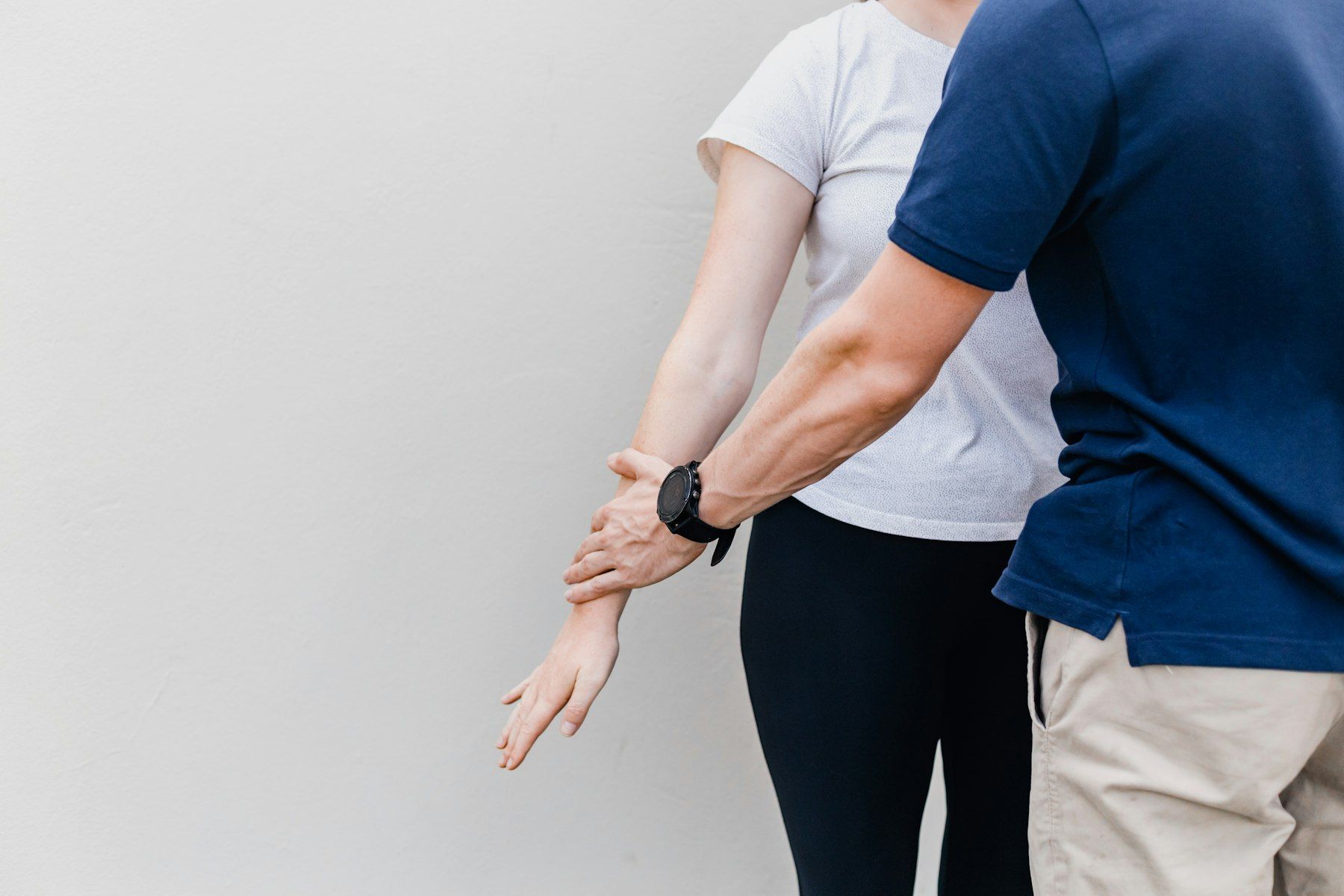 A therapist guides a patient through an arm stretch
