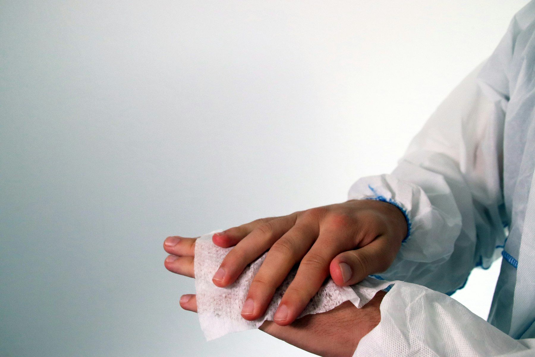 A clinician dresses the back of a patient’s hand