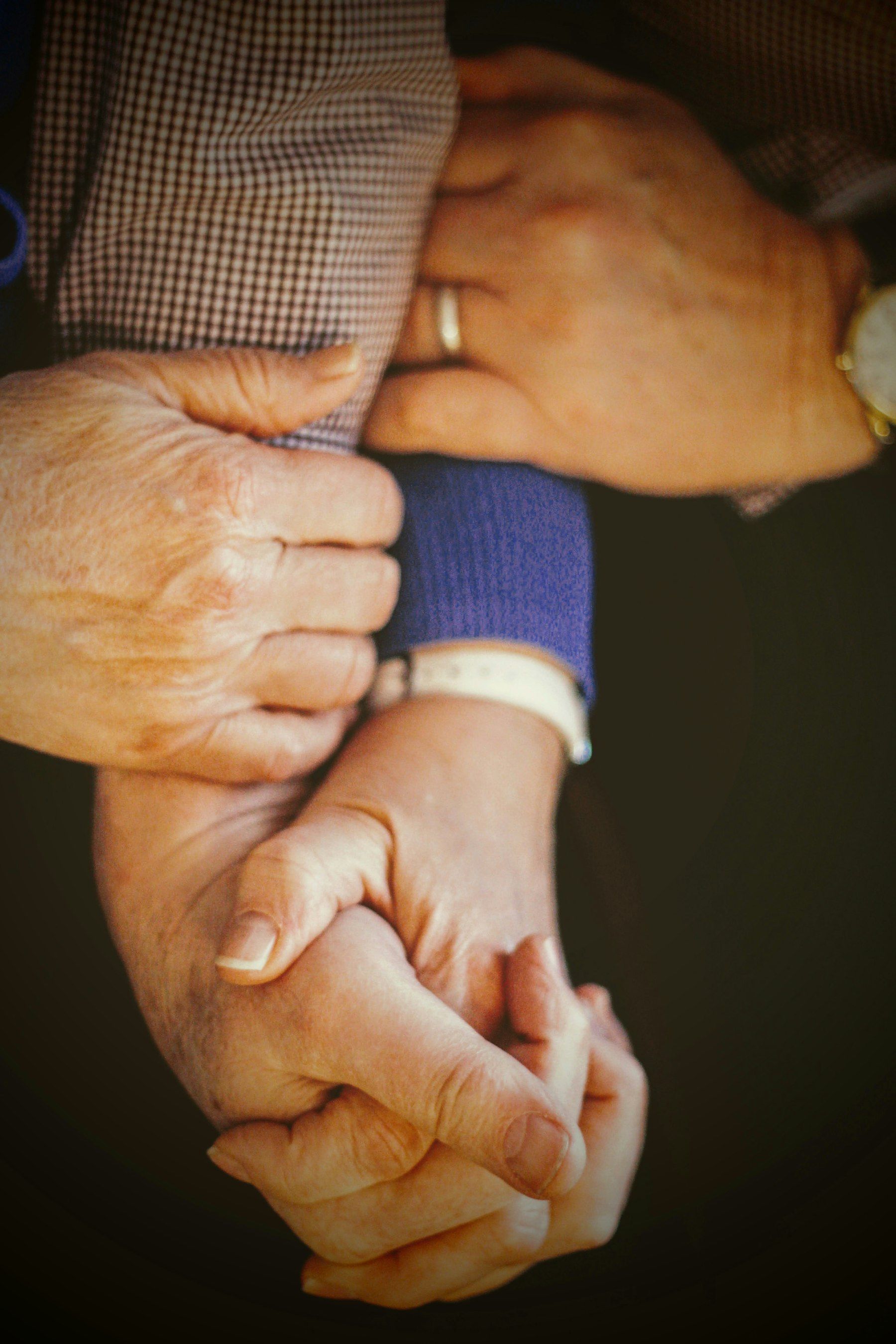 Three pairs of hands held together